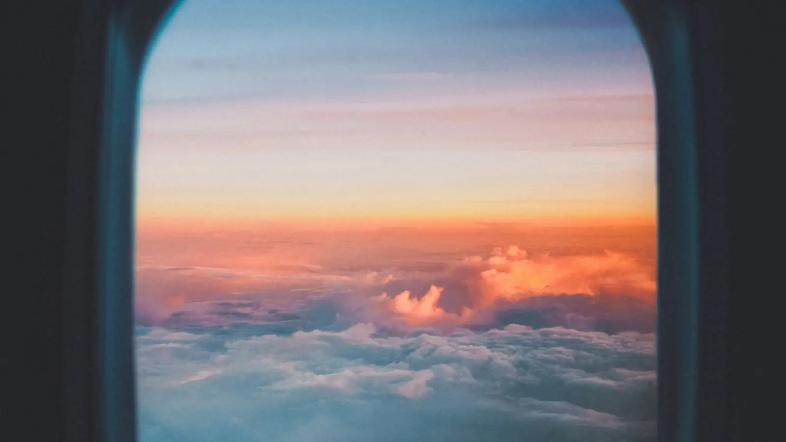Clouds at sunset seen through an aircraft window
